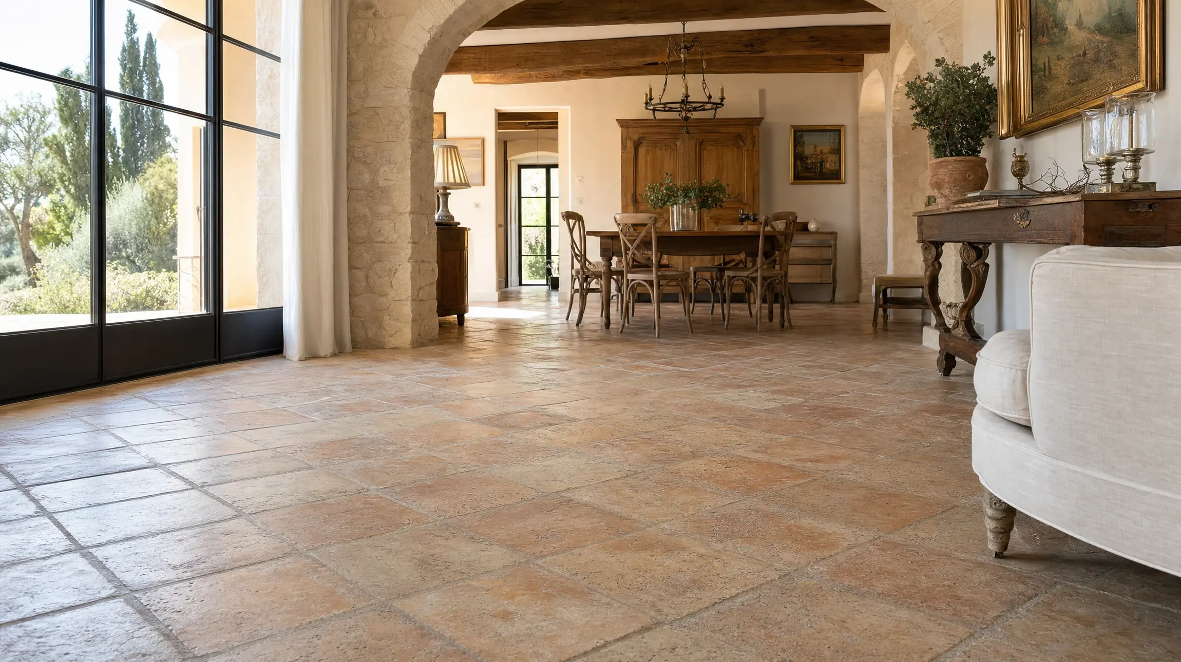 Terrasse extérieure d'une maison avec toiture en tuiles terre cuite, murs beiges et menuiseries blanches
